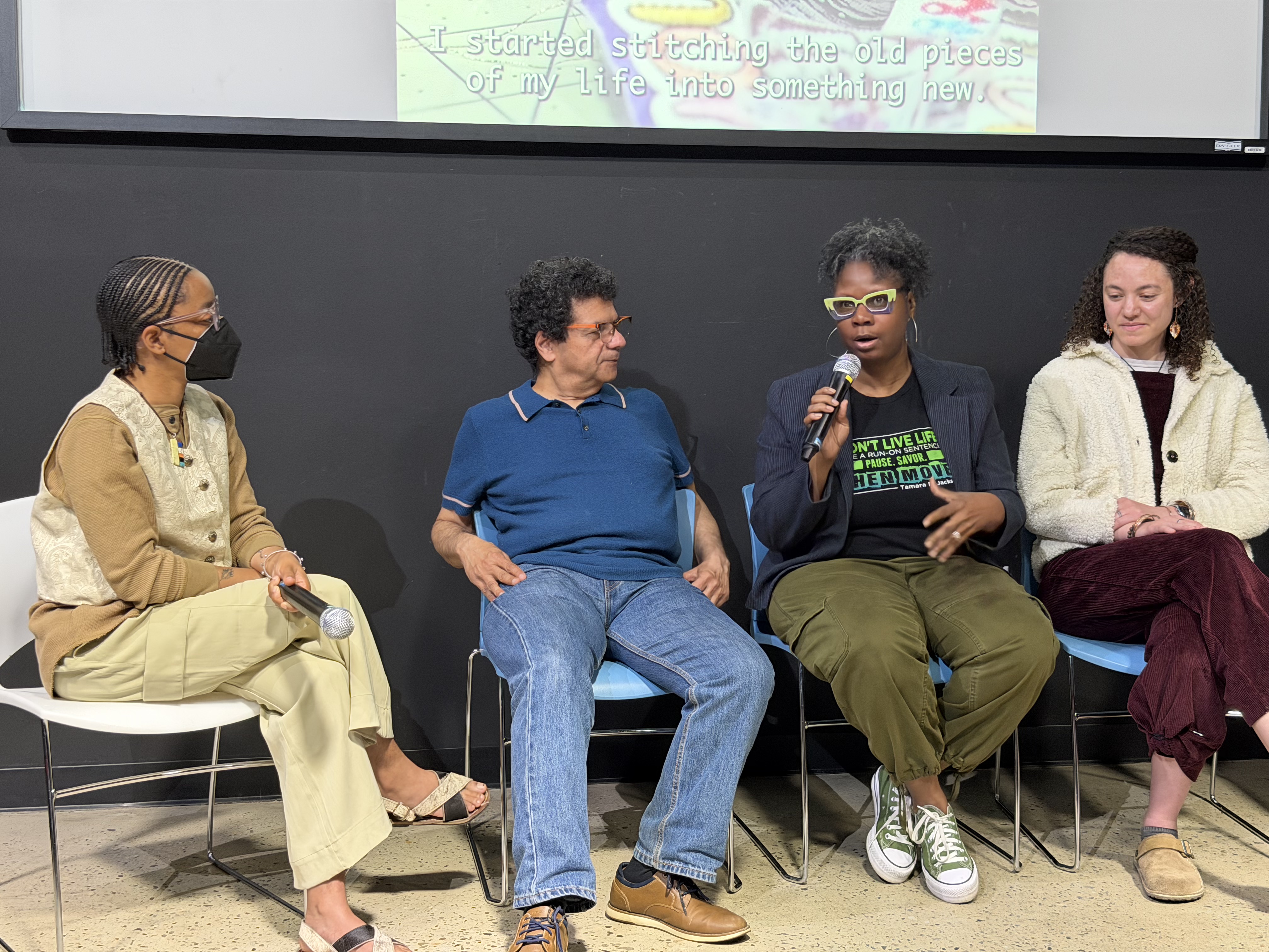 A closer view of 4 of the filmmakers during the Q and A portion. 3 flimmakers, one is speaking into a handheld microphone. the fourth person on the left is Ingrid, panel moderator.